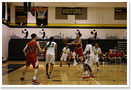 Basketball player shooting a ball into a hoop during a basketball game