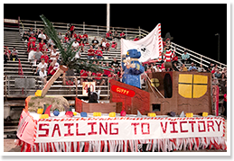 Sailing to Victory float in front of bleachers